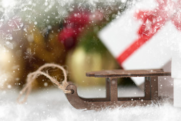 toy sleigh and Christmas decorations as background, decorated with snow
