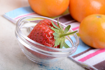 Close-up detail of a fresh red strawberry with leaves