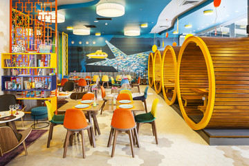 Wide shot of modern interior of colorful cafe