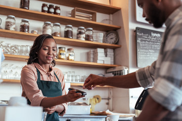 Cafe customer paying for his purchace with nfc technology