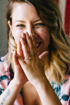 portrait of young female laughing in front of american flag