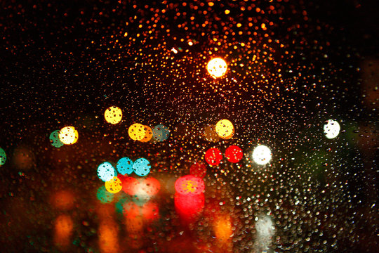 Wetwindow with the background of the night city