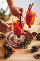 Beautiful Christmas background with mulled wine in a glass, gingerbread and New Year decor