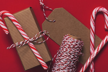 Festive Christmas present with candy cane on a red background