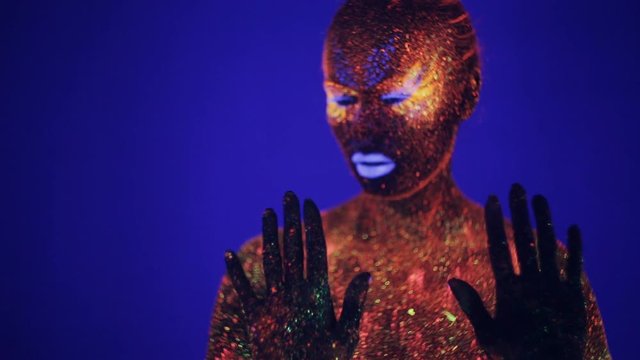 Woman with fluorescent make up , creative makeup great for nightclubs, party, shows and music video