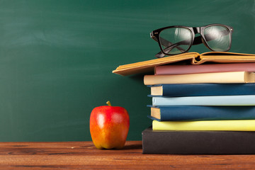 back to school - apple and books with pencils and blackboard
