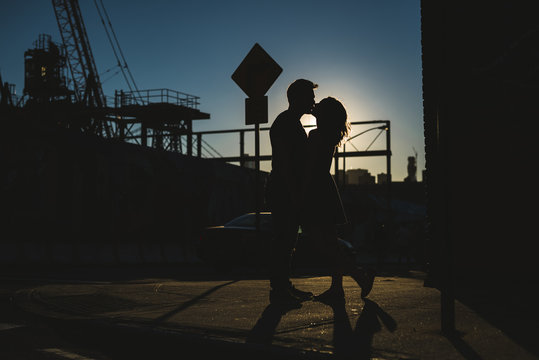 Young couple silhouette kissing in the city