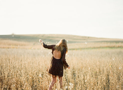 Girl playing a soy field with seed fluff