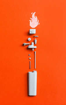 White disassembled lighter  on orange/red background