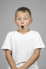 Little boy is wondering with white shirt on white background