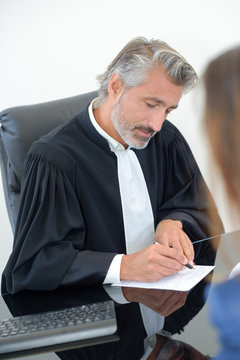 judge writing on paper