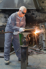 worker cutting metal