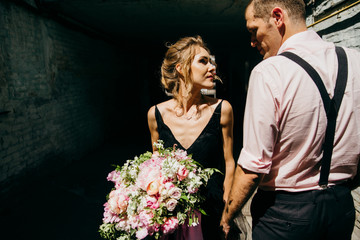 Wonderful bride and groom in the small street at sunny day