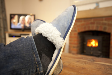 feet up in front of the fire watching television