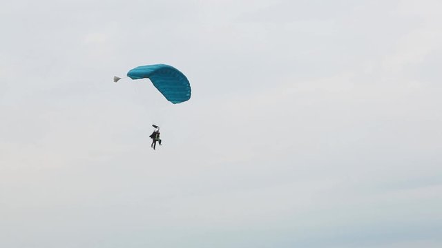 The parachutist jumps along with the instructor.