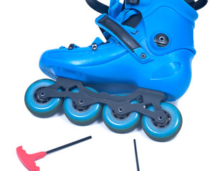 Blue roller skates with allen wrench isolated on white background