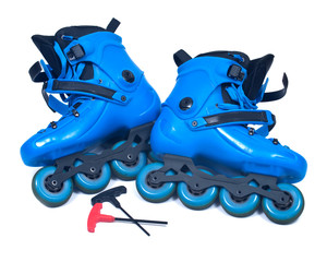 Blue roller skates with allen wrench isolated on white background