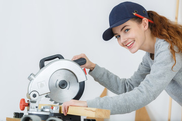 female carpenter using circular saw