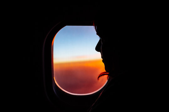 Silhouette of a Woman Sitting in an Airplane