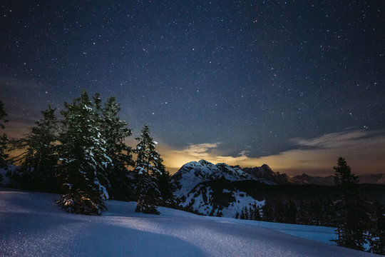 snowcovered austrian mountains under starry night