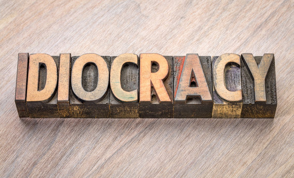 idiocracy word abstract in wood type