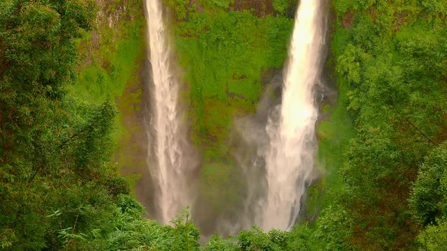 Tad Fane Waterfall, a picturesque twin set of waterfalls spilling over 100 meters down from the Bolaven Plateau into a deep gorge, located in the jungle of Dong Hua Sao, Laos.