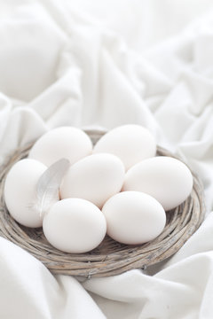White shell eggs in a twig basket