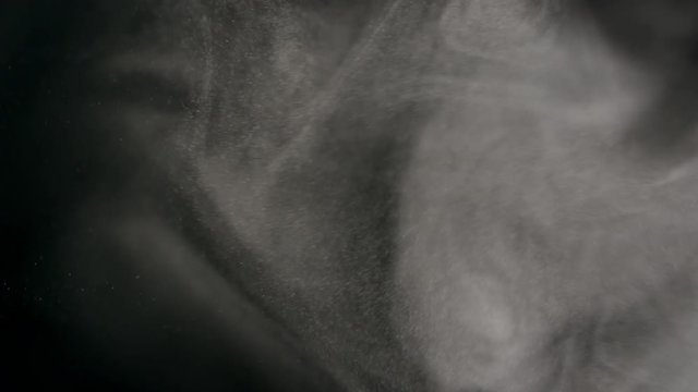 Smoky fog clouds over a black background. You can add this footage to your video project by dropping it in and changing its blending mode to Screen or Add