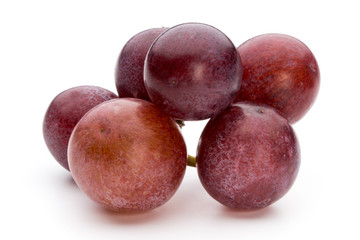 Ripe red grape isolated on white.