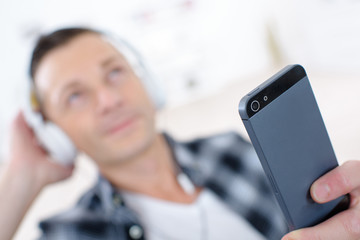 handsome man listens to music in his ipod