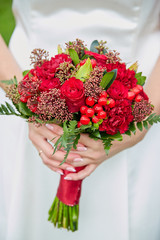 the bride is holding a bouquet of flowers