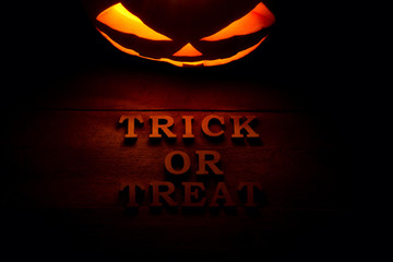 The concept of Halloween. Glowing with hot light angry terrible pumpkin. jack lantern in the dark,...