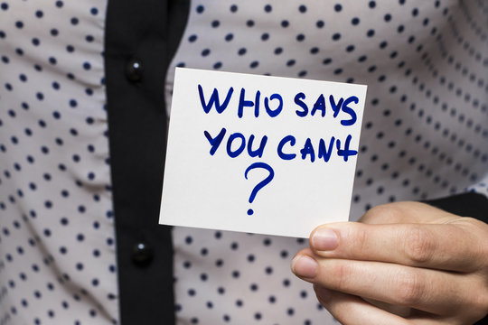 a woman holds a sheet with the inscription "who says you can't?"concept for self belief, positive attitude and motivation