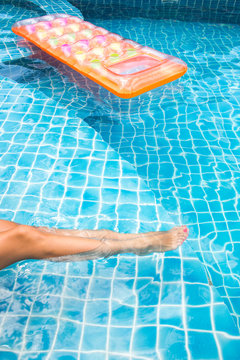 Woman relaxing at the swimming pool