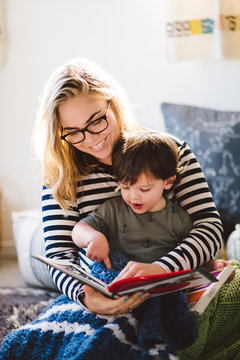 Mother and young son reading a book together