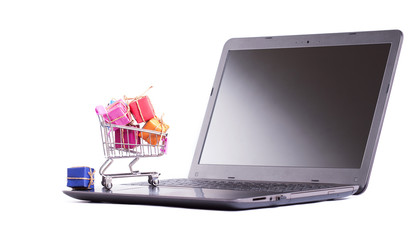 shopping cart full with gift box on laptop