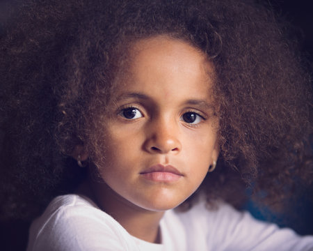Closeup portrait of thoughtful young girl with frizzy hair