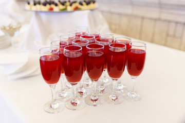 Filled with glasses of cocktail. Top view of wine glasses filled of red juice. The glasses are in the shape of a diamond.