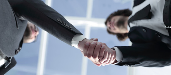 Friendly smiling businessmen handshaking. Business concept photo