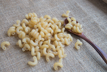 Cavatappi raw pasta on rustic background . Natural and healthy food concept.