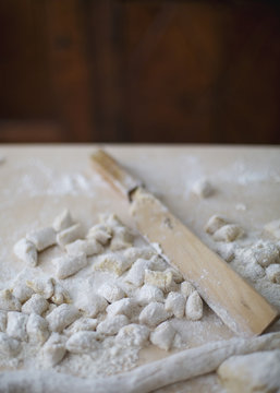 Still life of homemade potato gnocchi and dedicated wooden knife