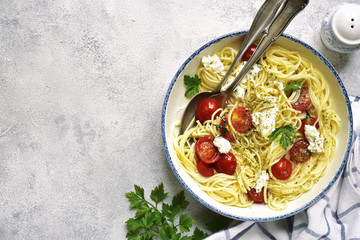 Spaghetti with tomatoes and ricotta cheese.Top view with copy space.