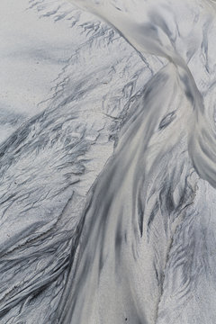 Patterns and textures in wet sand formed by receding tide