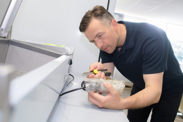 Man unwrapping plastic wrapped cable