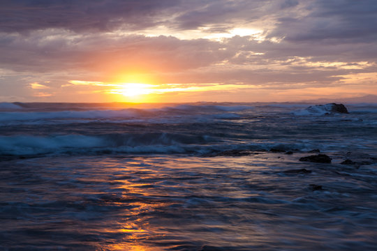 Sea scape waves sunset light glow and cloudy sky