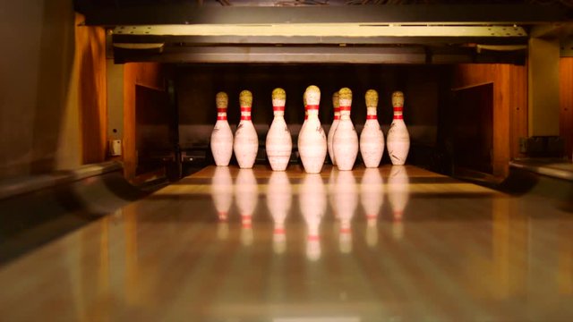 Bowling ball knocking pins on the bowling lane