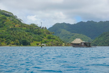 French Polynesia Huahine island coastline with a pearl oyster farm over the water in the lagoon, Faie, south Pacific ocean - obrazy, fototapety, plakaty