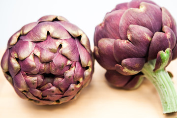 Artichokes with wooden kitchen board
