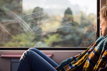 young woman sleeping on the train