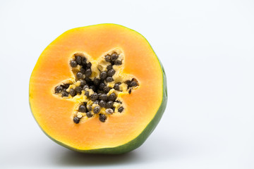 Papaya fruit - half and slice with seeds and light grey background
